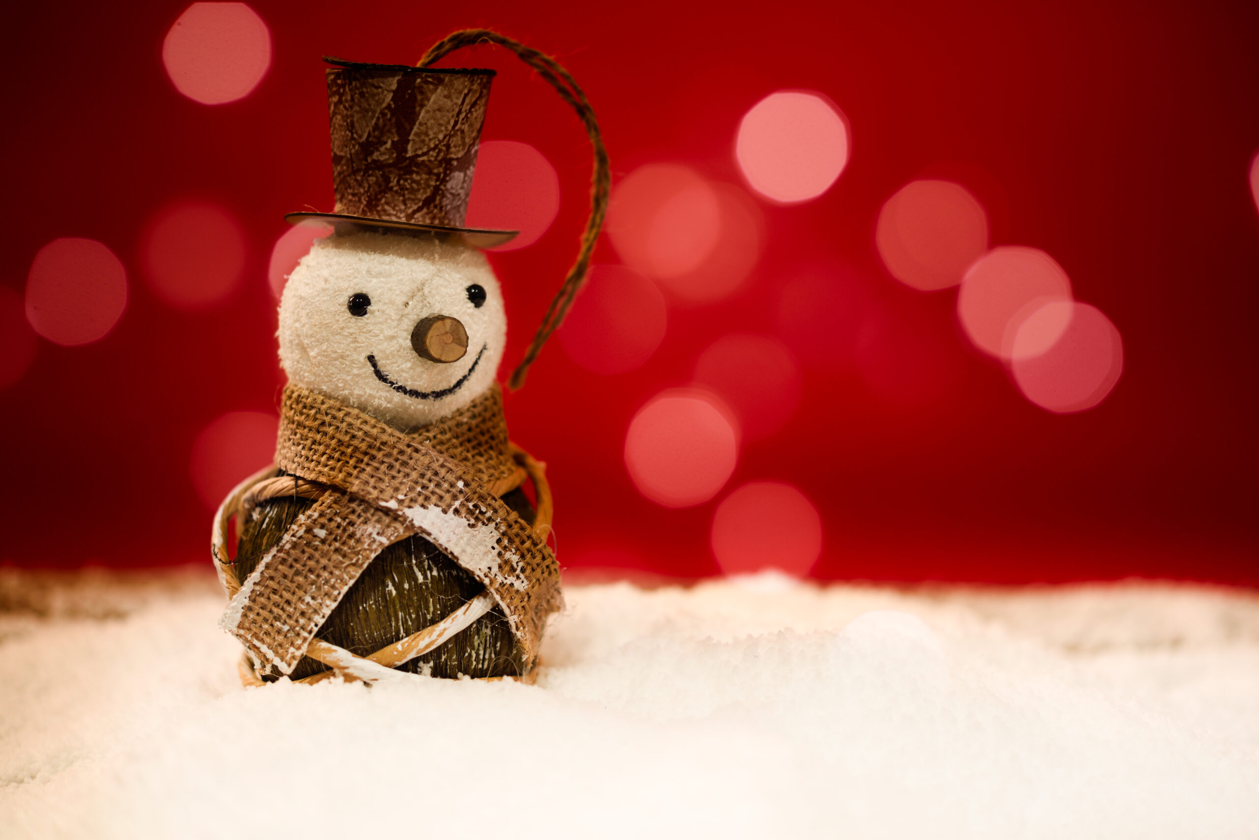 Snowman On Snow. Christmas Decoration With Red Background