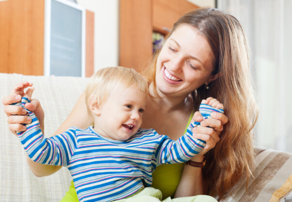 Happy Woman With Toddler On Sofa