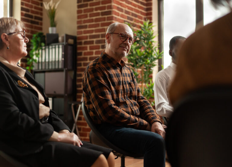 People Talking To Therapist At Aa Group Therapy Meeting, Sharing Addiction Problems