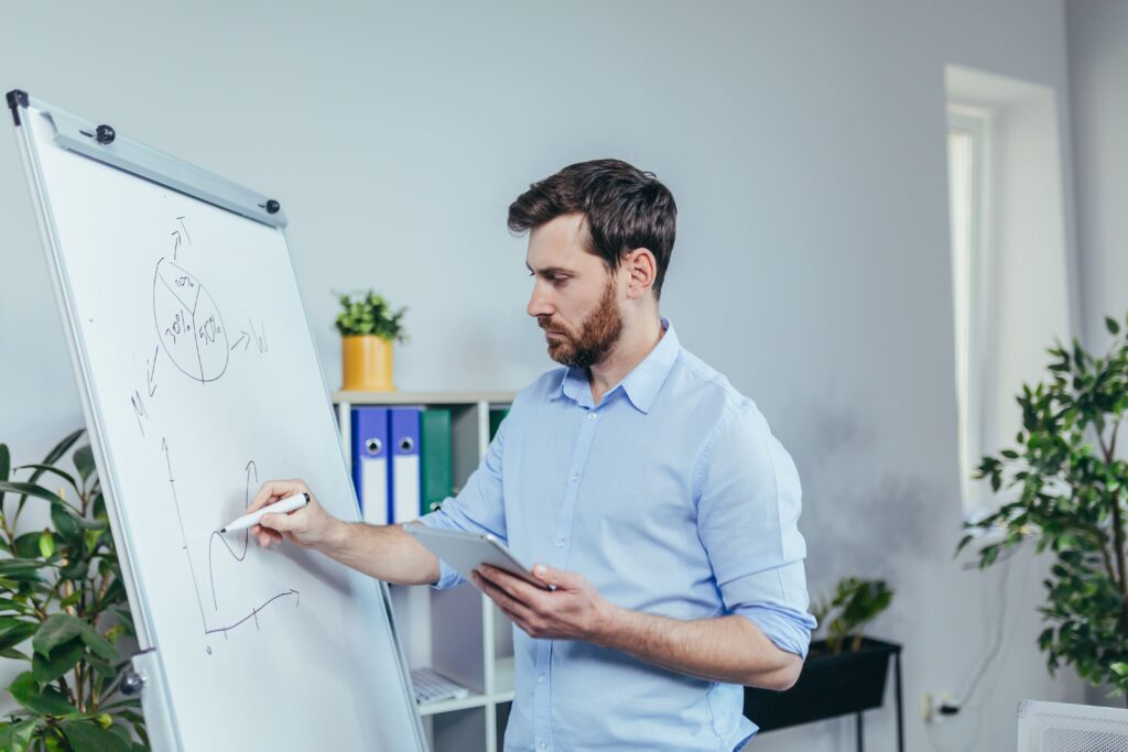 Young Businessman Writing On White Board With Mark 2025 03 28 10 49 46 Utc (1)